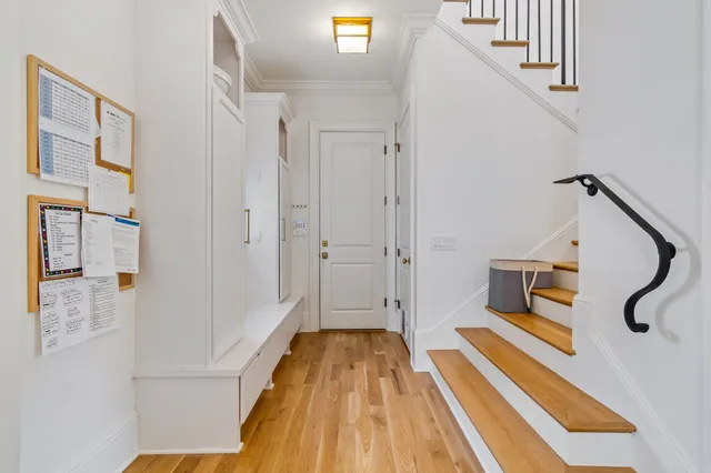 a spacious bedroom with a bed and wooden floor