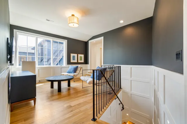 a bedroom with a bed a large window with furniture