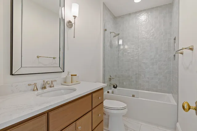 a bathroom with a toilet a sink and a mirror