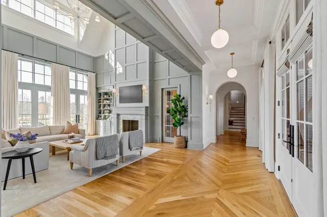 a living room with furniture fireplace and potted plants