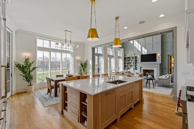 a kitchen with stainless steel appliances granite countertop a stove and chairs