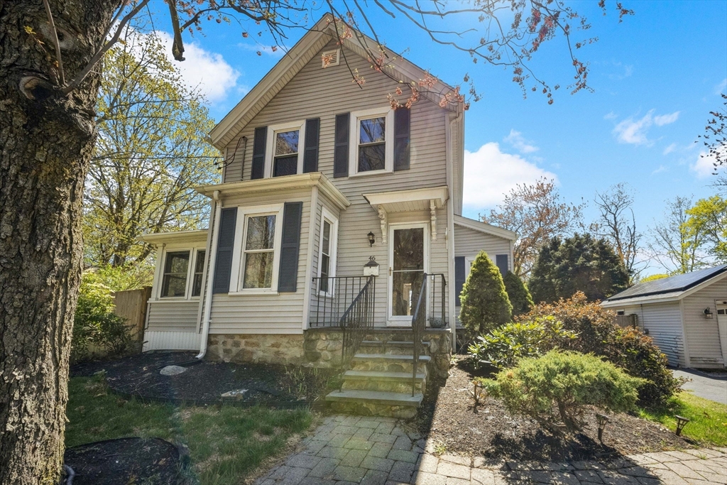 a front view of a house with garden