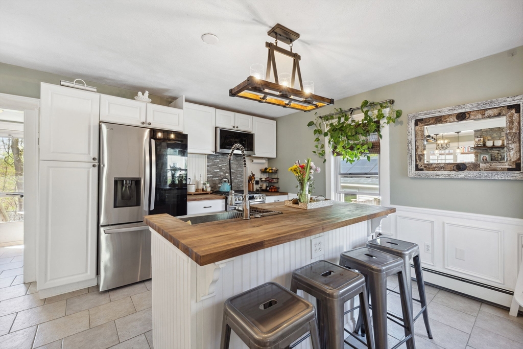 46 Appleton Street Saugus, MA 01906 - Photo 27 of 42 a kitchen with stainless steel appliances granite countertop a sink a stove and a refrigerator