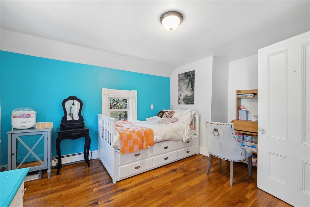 46 Appleton Street Saugus, MA 01906 - Photo 36 of 42 a bedroom with a bed and wooden floor