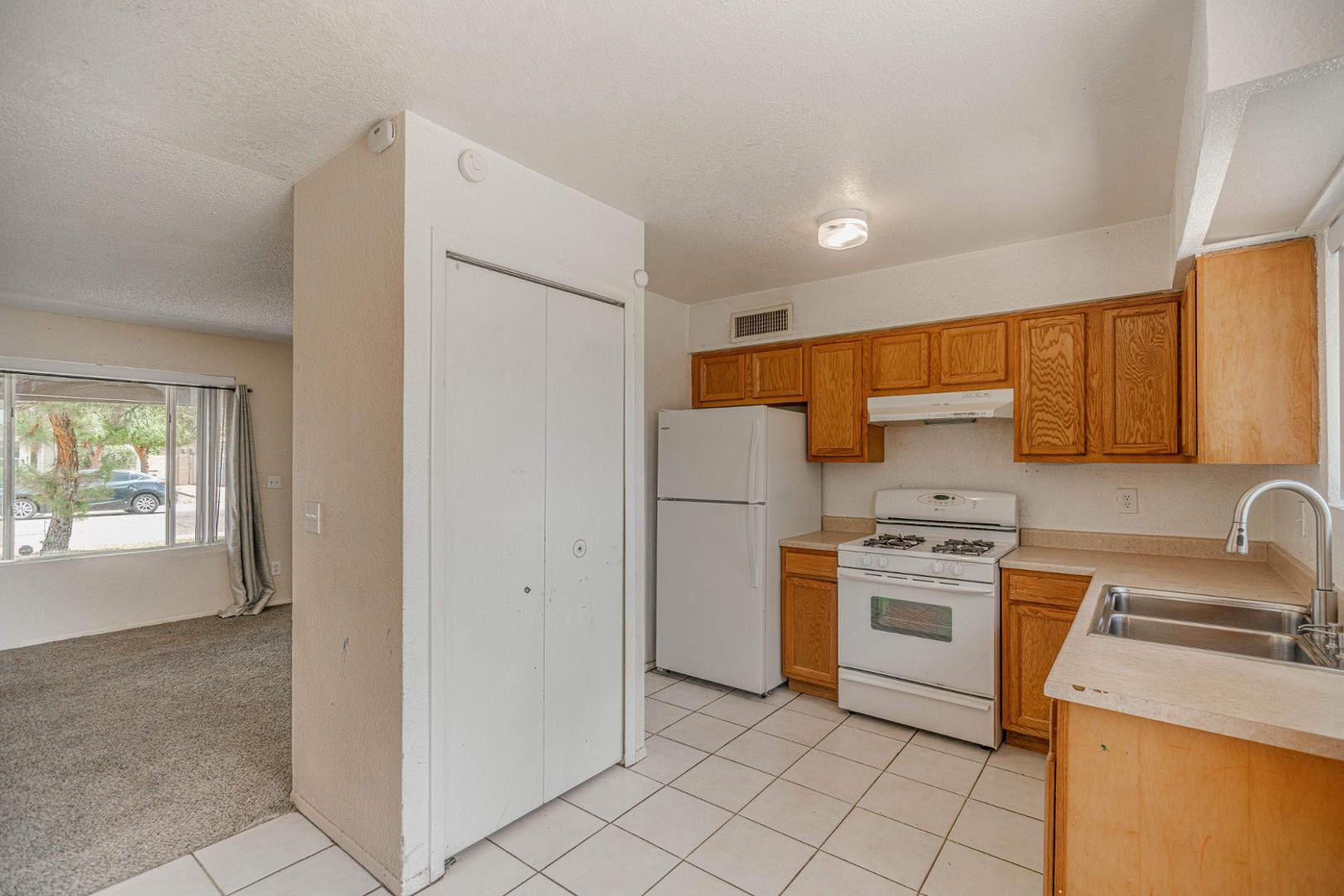 14626 North 38th Street Phoenix, AZ 85032 - Photo 10 of 13 a kitchen with a sink a stove and refrigerator
