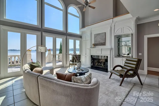 a living room with furniture a fireplace and a large window