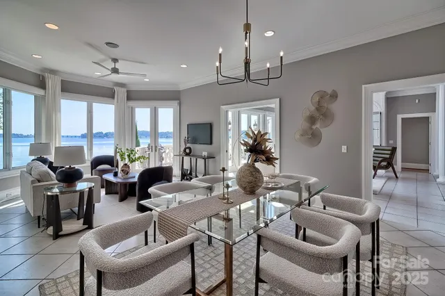 a living room with furniture kitchen view and a chandelier