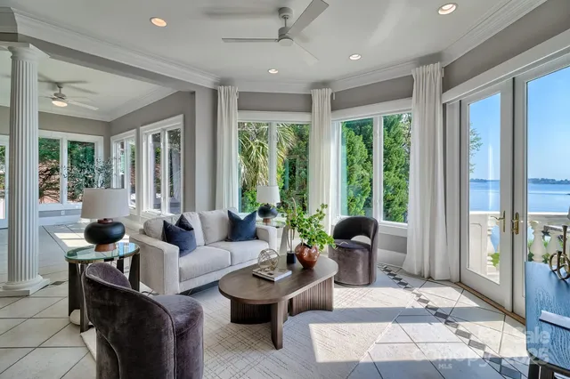 a living room with furniture and large windows