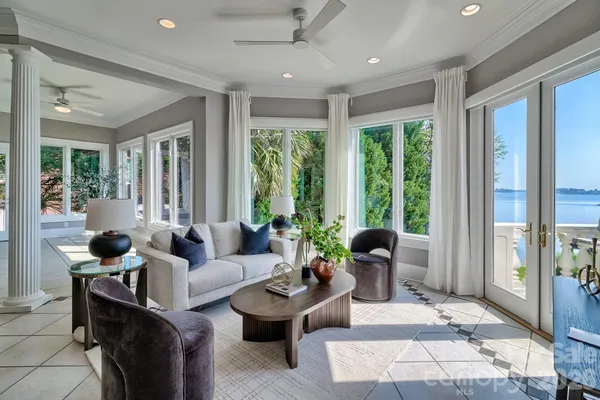 a living room with furniture and large windows