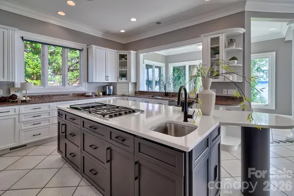 a kitchen that has a sink and a stove in it