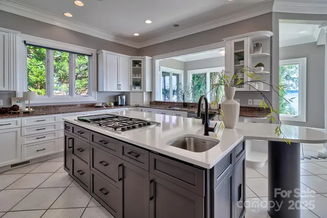 a kitchen that has a sink and a stove in it