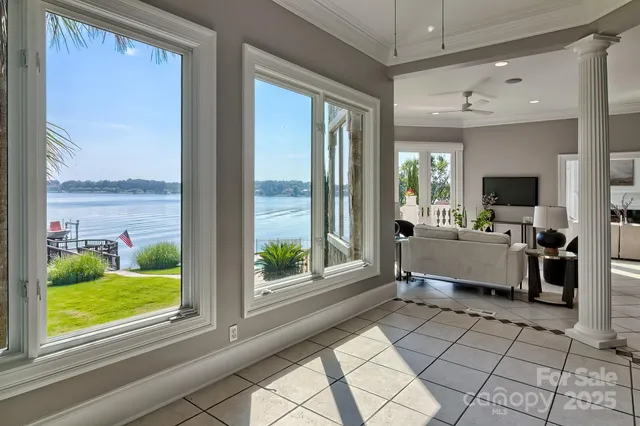 a living room with a large window and a rug