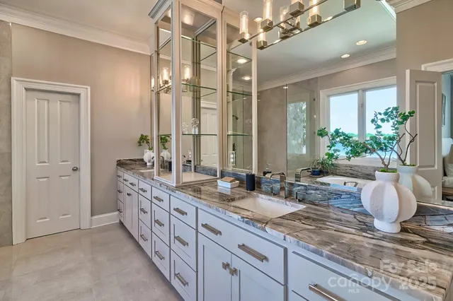 a spacious bathroom with double sink and a large mirror