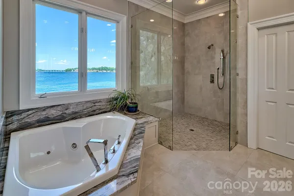 a bathroom with a tub a sink and shower