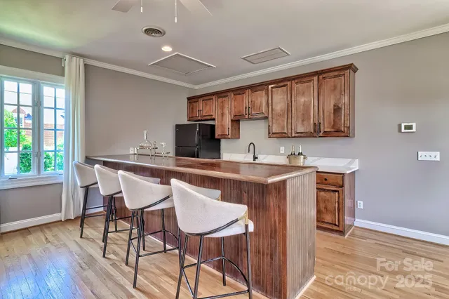 a kitchen with granite countertop wooden cabinets and dining table