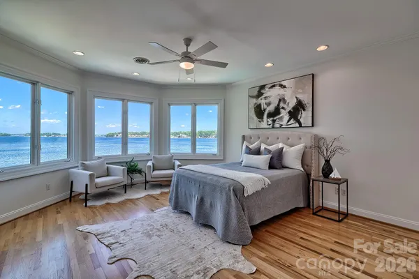 a bathroom with a granite countertop toilet sink and mirror