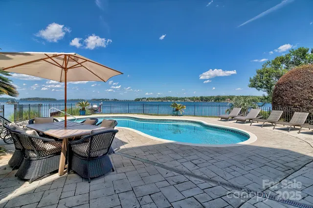 an outdoor space with swimming pool and furniture