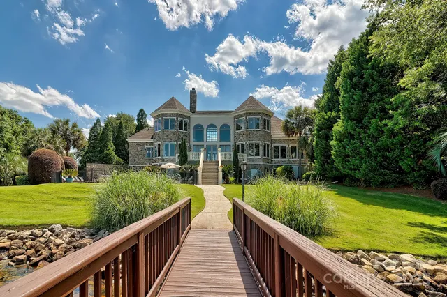 a view of a house with backyard and balcony