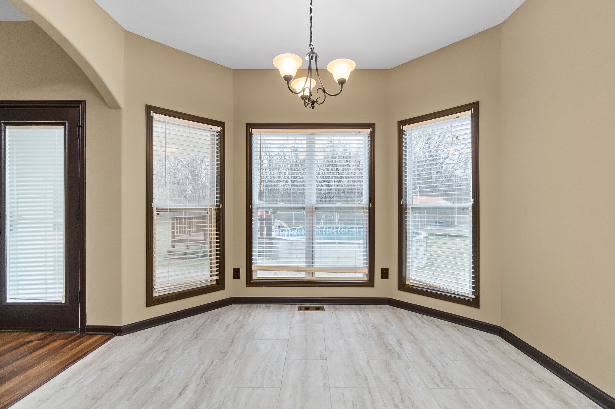 721 Needmore Road Clarksville, TN 37040 - Photo 13 of 40 a view of an empty room with wooden floor and a window
