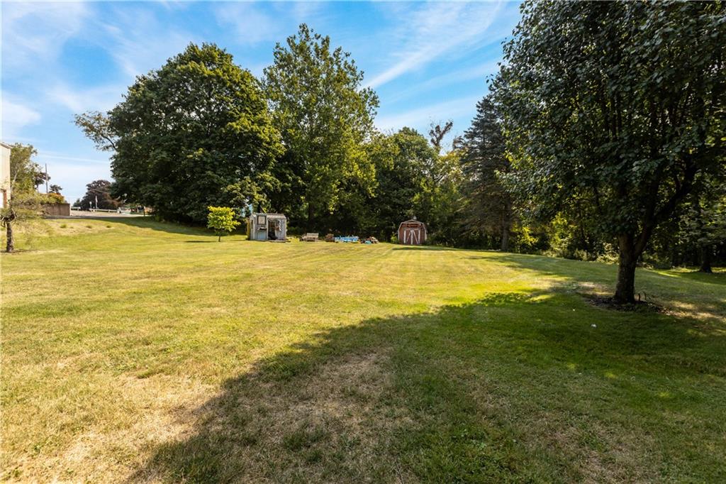 2172 Mercer Road New Brighton, PA 15066 - Photo 3 of 35 a view of a swimming pool with an outdoor space and seating area