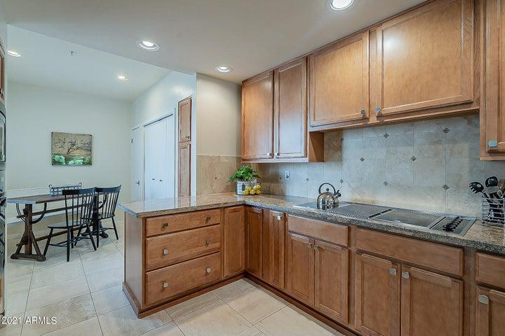 7700 East Gainey Ranch Road, Unit 153 Scottsdale, AZ 85258 - Photo 5 of 24 a kitchen with a sink and cabinets