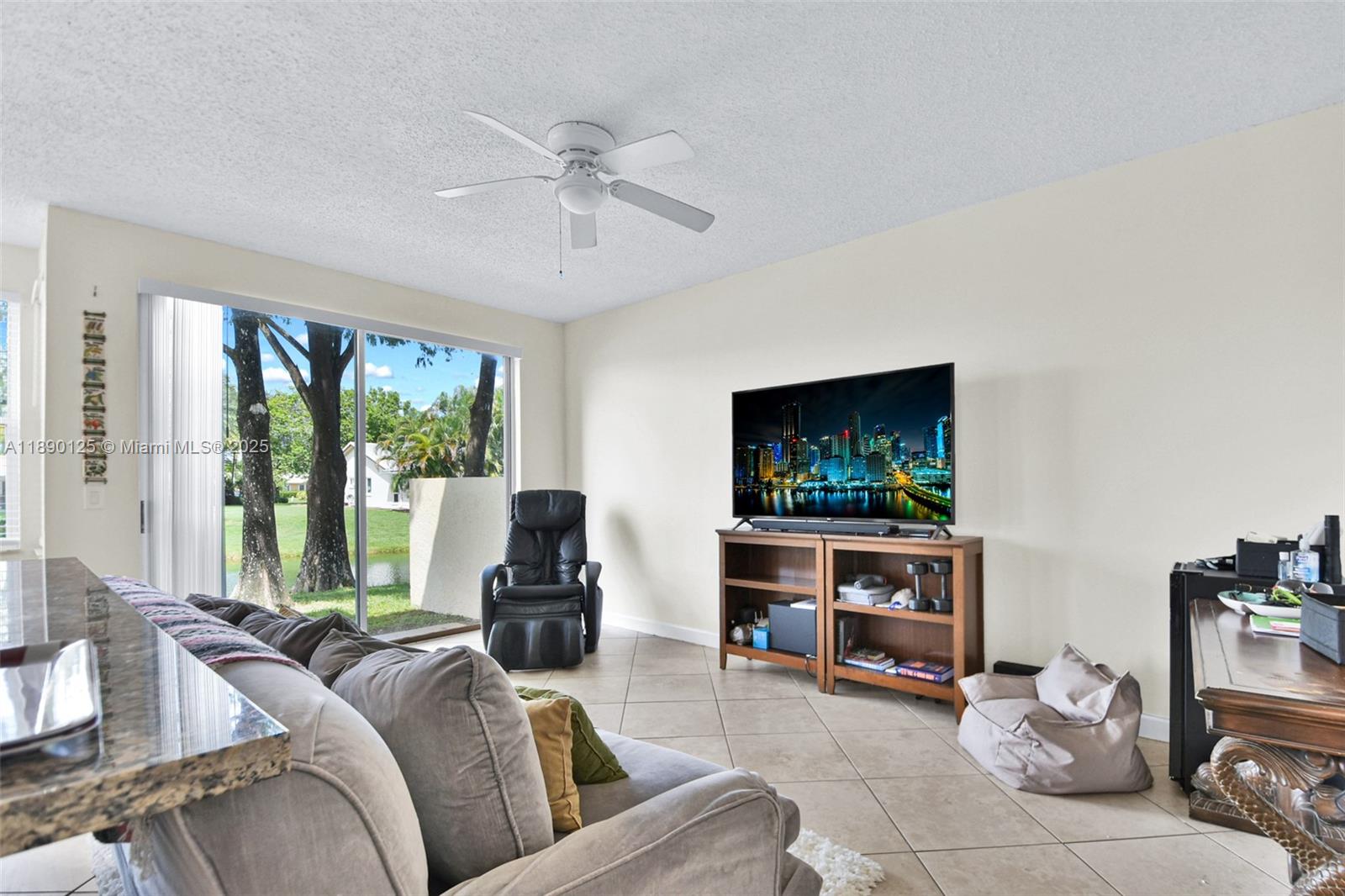 8713 Northwest 6th Court, Unit 8713 Coral Springs, FL 33071 - Photo 12 of 38 a living room with furniture and a flat screen tv