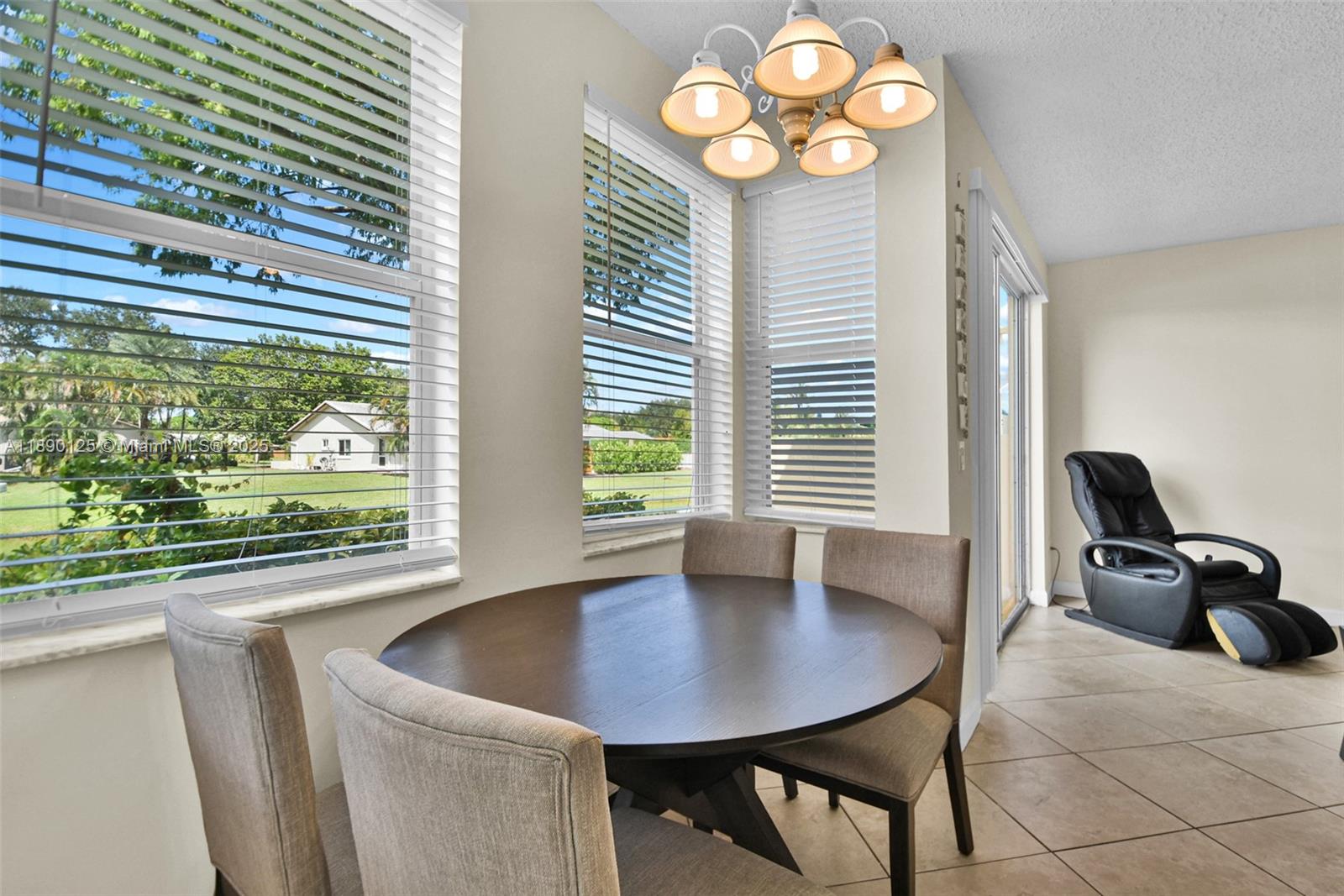 8713 Northwest 6th Court, Unit 8713 Coral Springs, FL 33071 - Photo 18 of 38 a view of a dining room with furniture and a large window