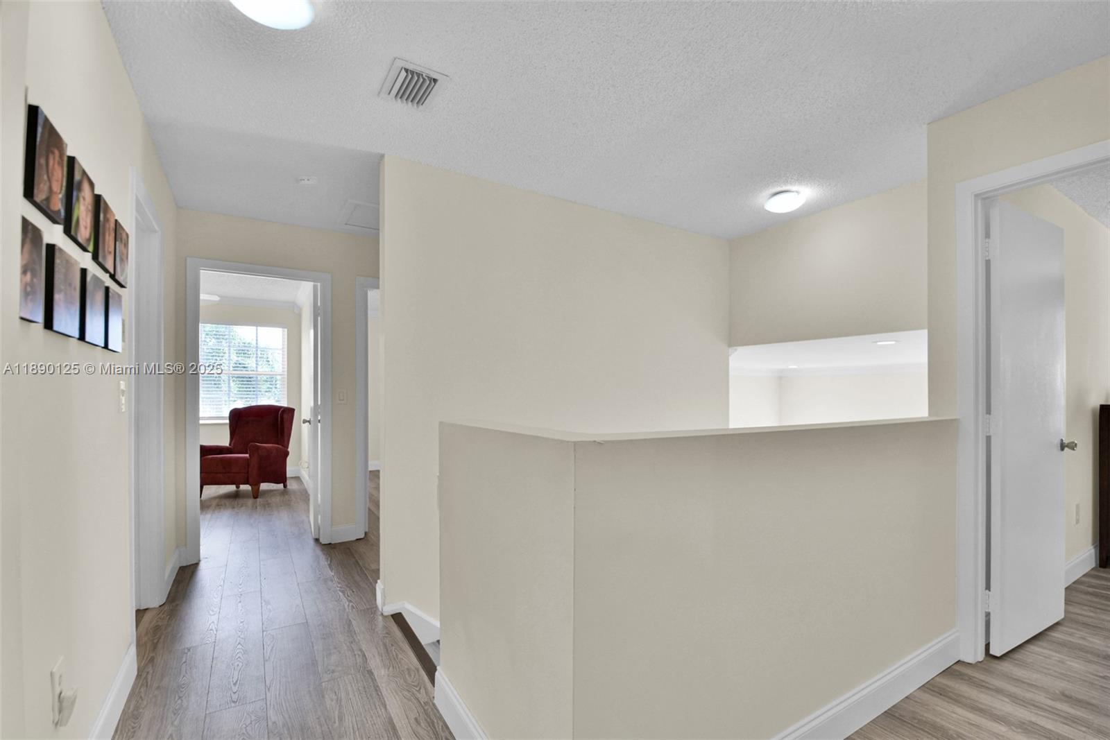 8713 Northwest 6th Court, Unit 8713 Coral Springs, FL 33071 - Photo 21 of 38 a view of a hallway with wooden floor and a living room