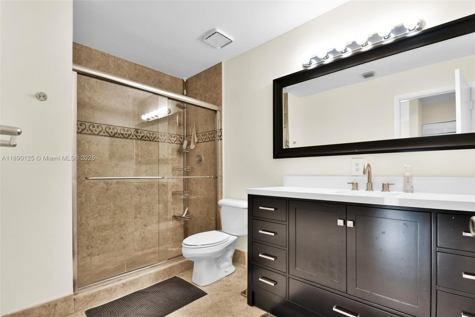 8713 Northwest 6th Court, Unit 8713 Coral Springs, FL 33071 - Photo 28 of 38 a bathroom with a sink toilet and shower