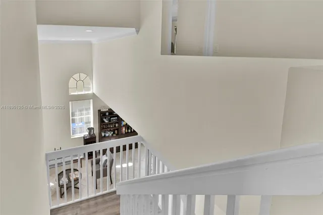 a view of staircase with white walls and a window