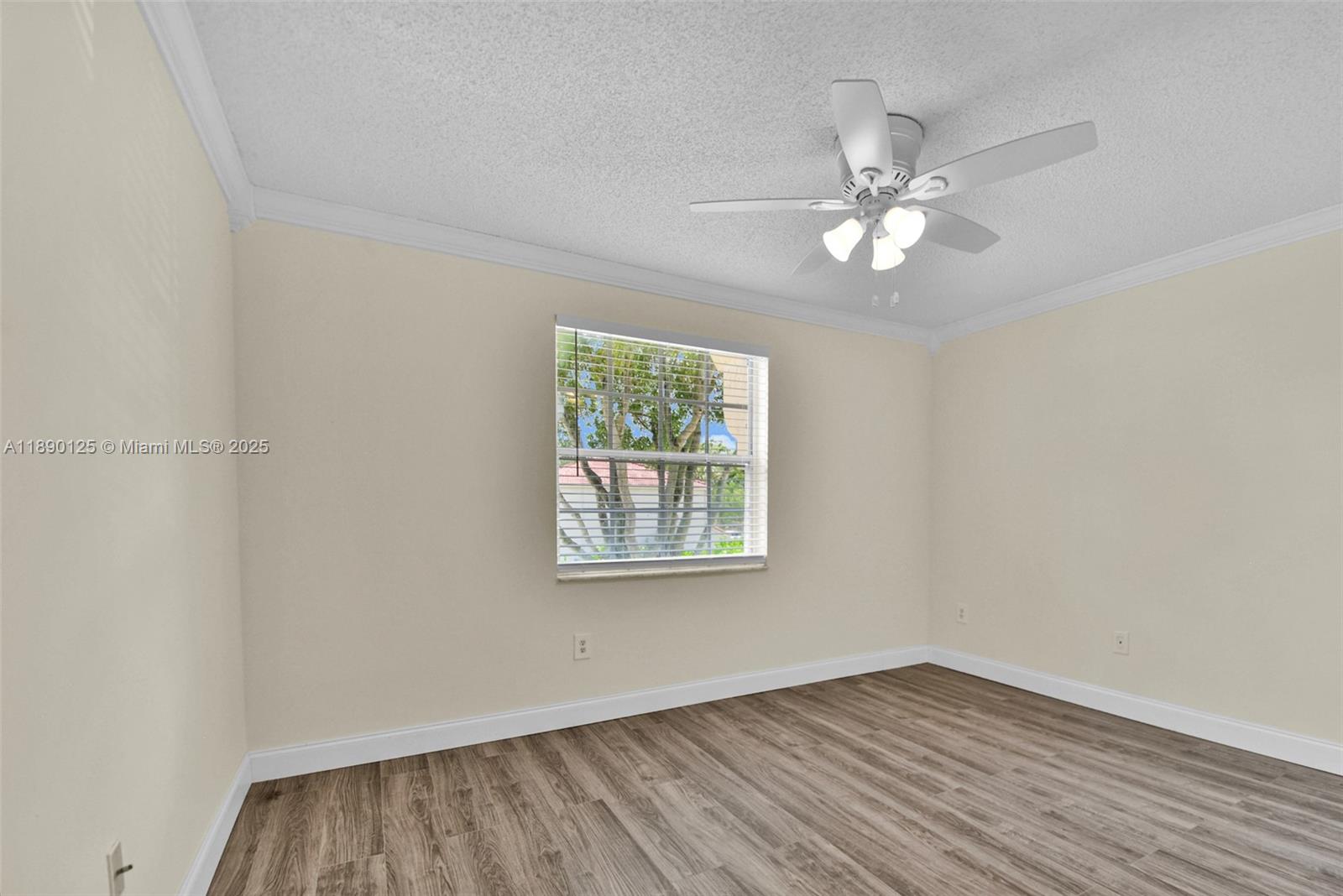 8713 Northwest 6th Court, Unit 8713 Coral Springs, FL 33071 - Photo 30 of 38 a view of an empty room with wooden floor and a window
