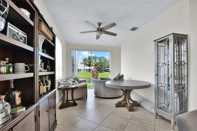 a room with a table chairs and a book shelf
