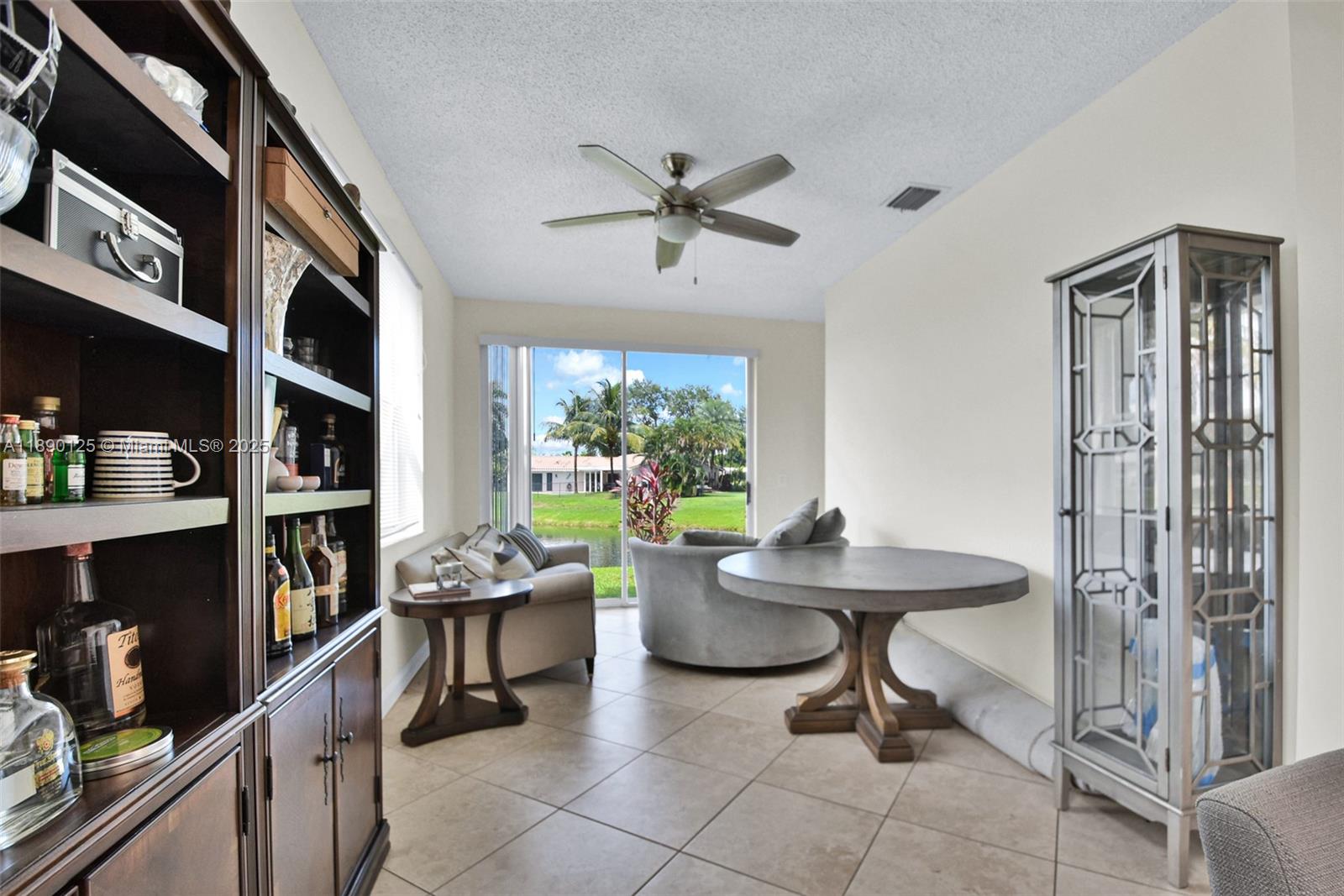 8713 Northwest 6th Court, Unit 8713 Coral Springs, FL 33071 - Photo 5 of 38 a room with a table chairs and a book shelf