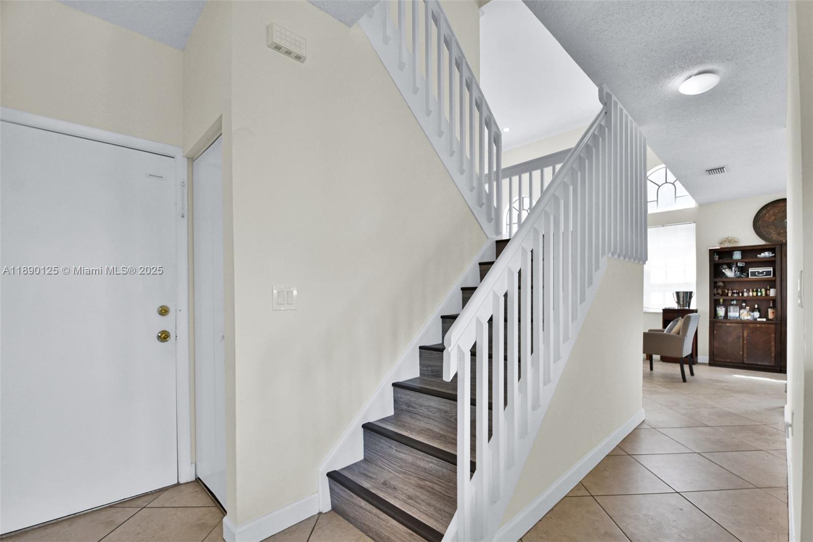8713 Northwest 6th Court, Unit 8713 Coral Springs, FL 33071 - Photo 9 of 38 a view of staircase with lots of frames and white walls