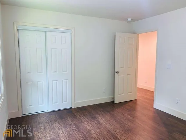 an empty room with wooden floor