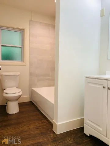 a bathroom with a toilet and a shower