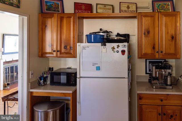 a white refrigerator freezer sitting inside of a kitchen