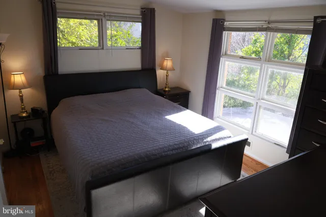 a bed sitting in a bedroom next to a window