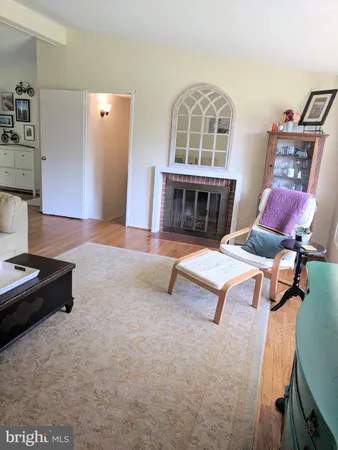 a living room with furniture rug and wooden floor