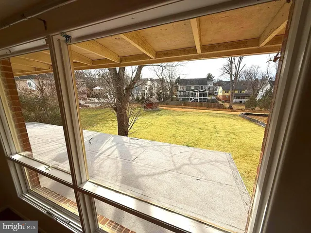 a view of a room with wooden floor and windows