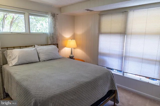 a bedroom with a bed and a night stand