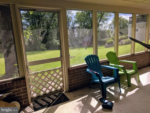 a living room filled with furniture and a floor to ceiling window