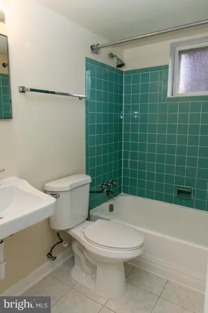 a bathroom with a toilet a sink and shower