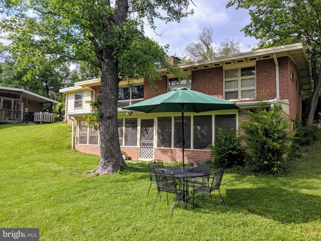 a front view of a house with a yard table and chairs