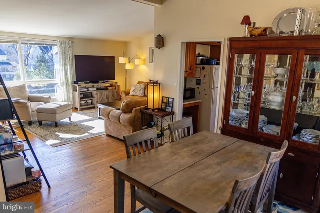 a living room with furniture a flat screen tv and a floor to ceiling window