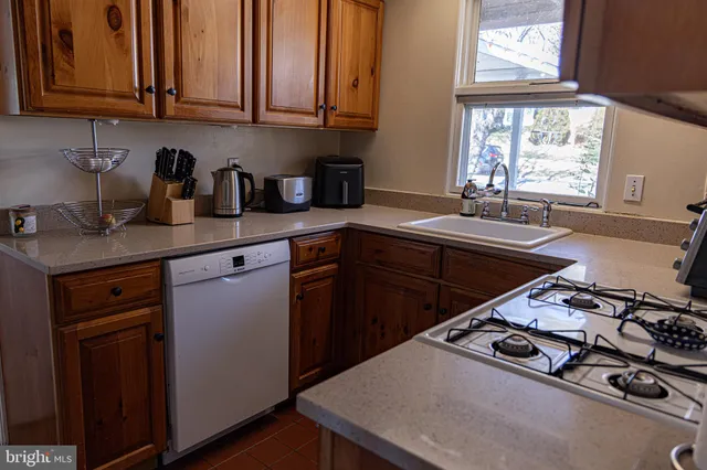 a kitchen with stainless steel appliances a sink stove and window