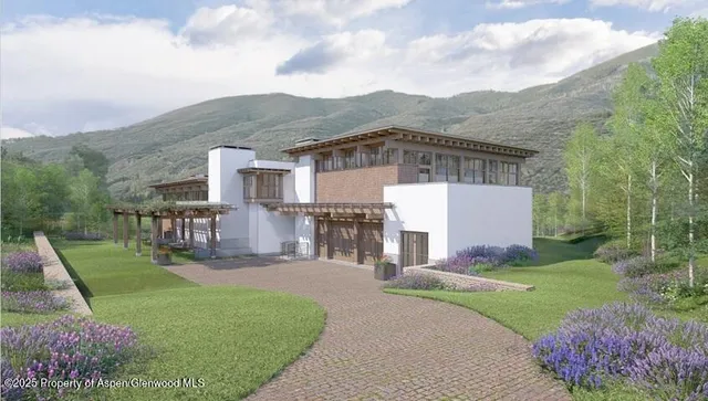 a view of a house with a big yard potted plants and large tree