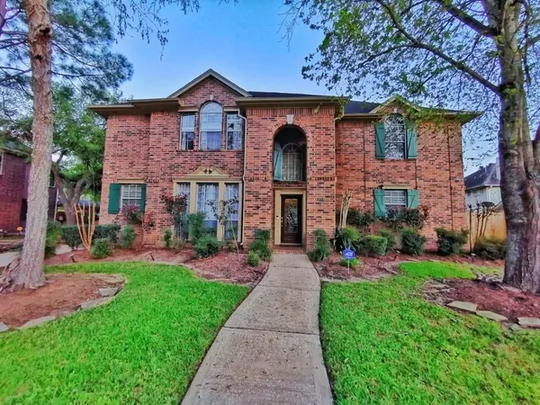 a front view of a house with a yard and pathway