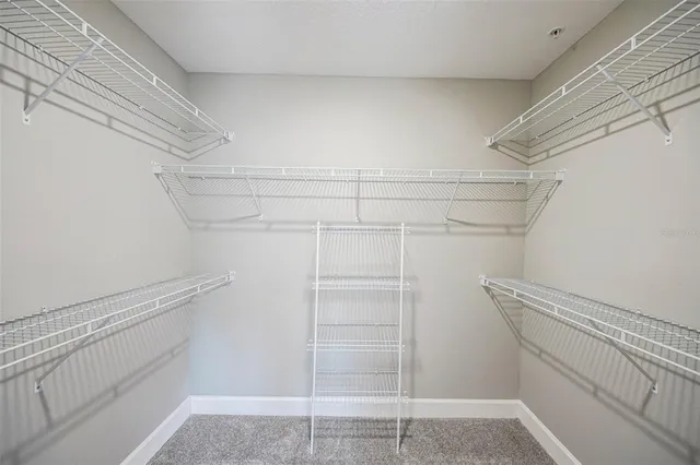 a view of walk in closet with empty racks