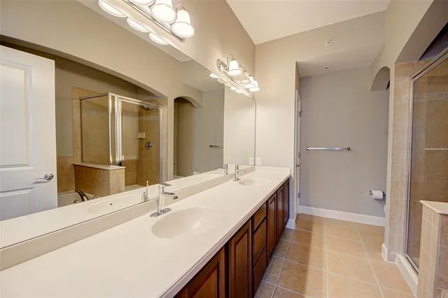 a bathroom with a double vanity sink and a mirror